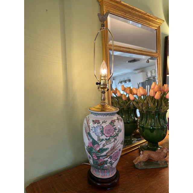 The porcelain body on this chinoiserie lamp is filled with hand painted pheasants and peonies on a white background. The...