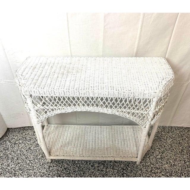 1940’s lattice wicker on a wood frame console table. Measures 36.6” w x 14.5” d x 40” h. No break to wicker , could use a...