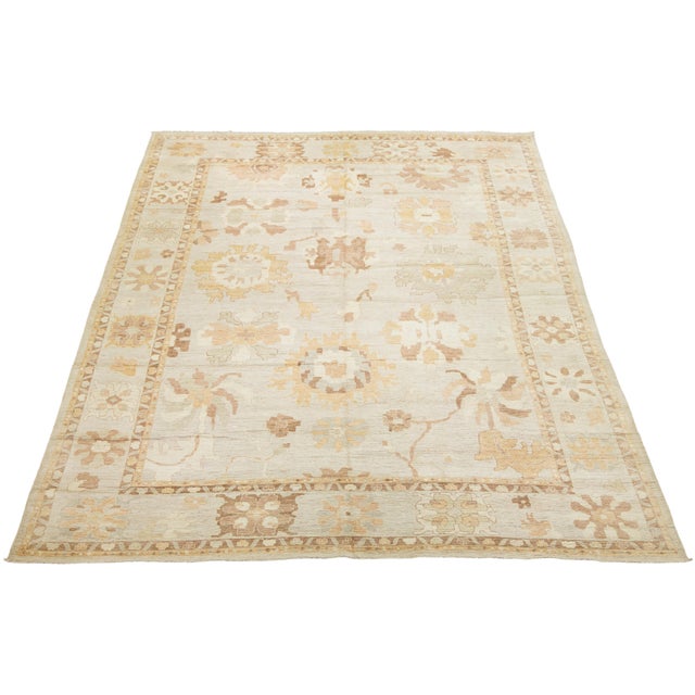 This magnificent oversized area rug captures the timeless elegance of traditional Turkish Oushak designs with a refreshed,...