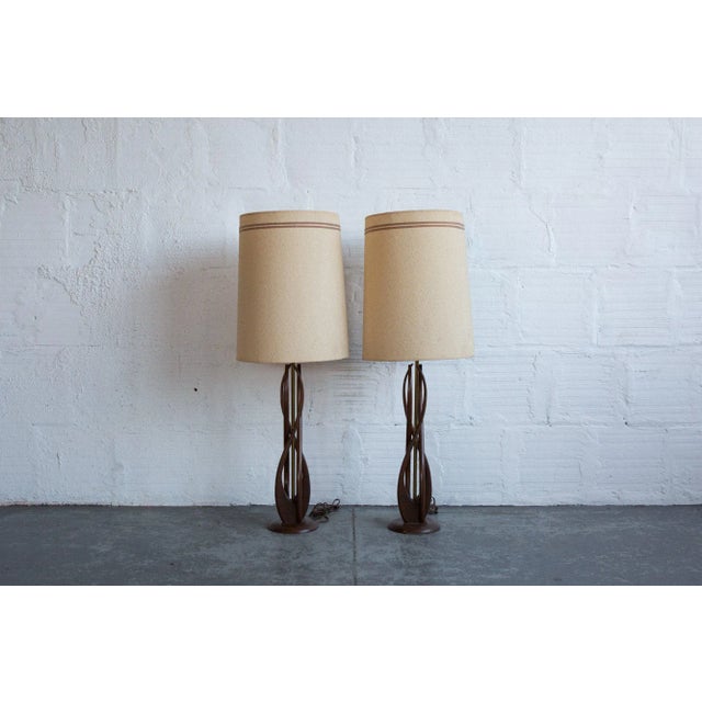 Vintage / Retro accent lighting. Enjoy a pair of continuously curving wood table lamps. The delicate design will impact...