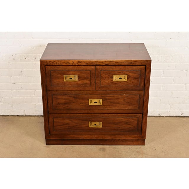 A gorgeous Mid-Century Modern Campaign bachelor chest In the manner of Henredon By Dixie USA, Circa 1970s Oak, with...