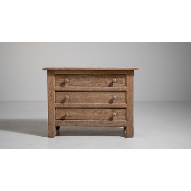 A robust oak chest reflecting the 1970s European focus on solid wood furniture and long-term durability. Unlike lighter...