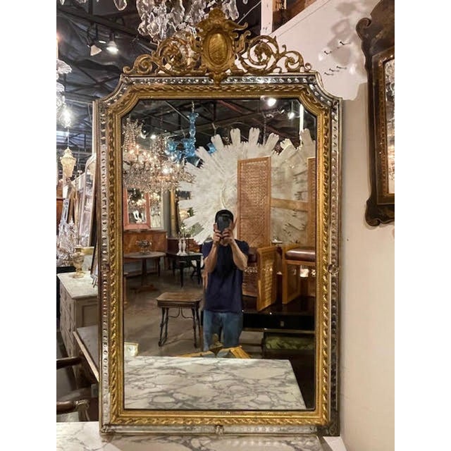 The 19th century French Louis XVI giltwood and etched mirror exudes elegance and sophistication. This mirror, crafted with...