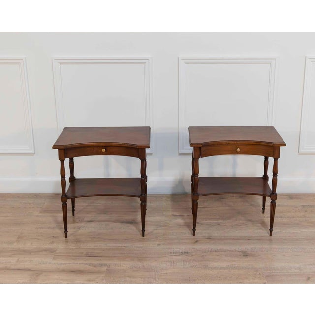 A balanced pair of Louis XVI–style bedside tables distinguished by their elegant proportions and restrained neoclassical...