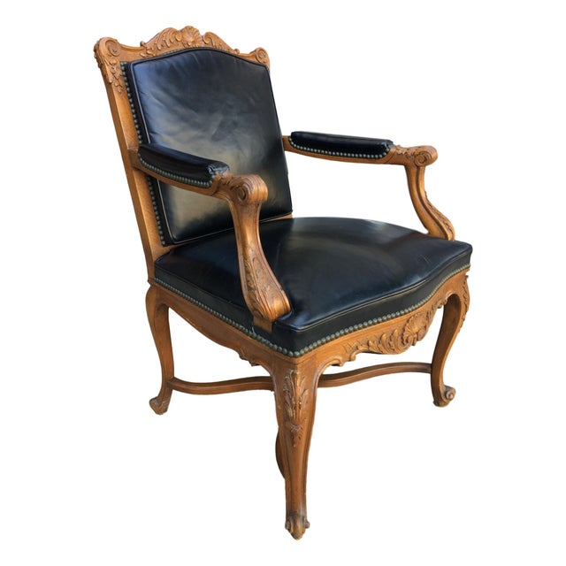 A vintage Louis XV style armchair by the acclaimed Danby Company. This walnut and black leather chair features a...
