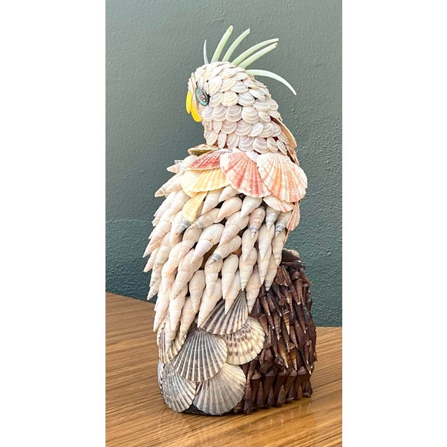 This whimsical vintage cockatoo figurine is a masterclass in the artisanal "coquillage" or shell art tradition....