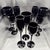 Nine pieces of black crystal—three flutes (~10 in / 25 cm), three water goblets (~9¾ in / 25 cm) and three wines (~8¼ in /...