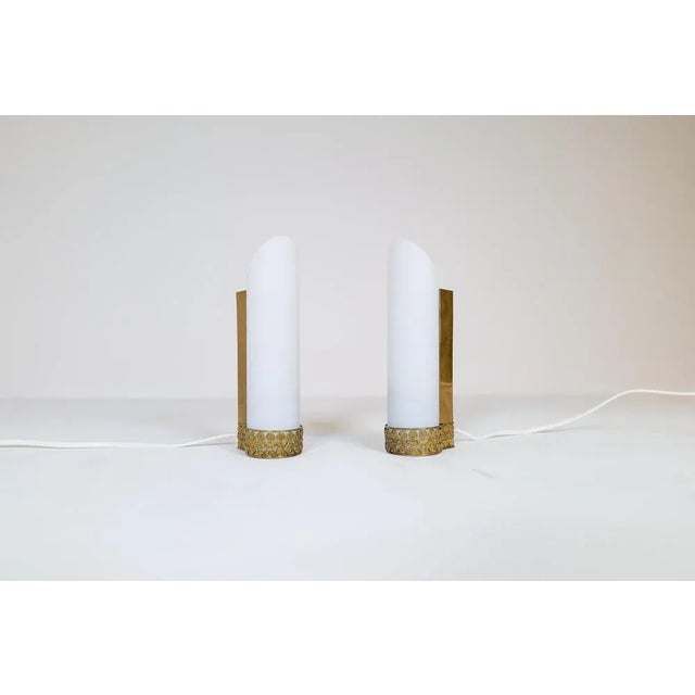 These wall mounted lamps were created in Sweden during the 1950s. They were most likely produced by ASEA. The ends of the...