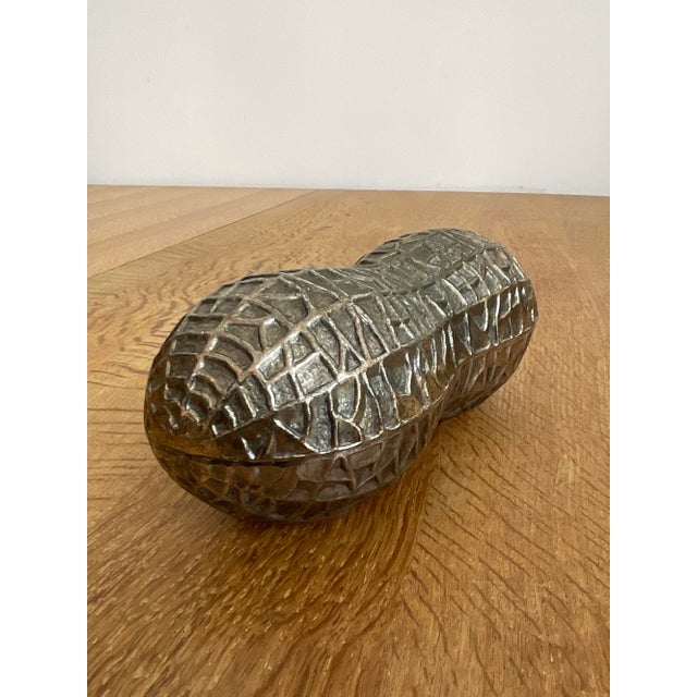 Whimsical, textured, and uniquely functional, this vintage silver plated lidded trinket box is crafted in the detailed...
