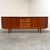 Remarks: Skovby sideboard designed by Arne Vodder, Denmark 1960s. Teak veneer with four slide doors and five drawers....