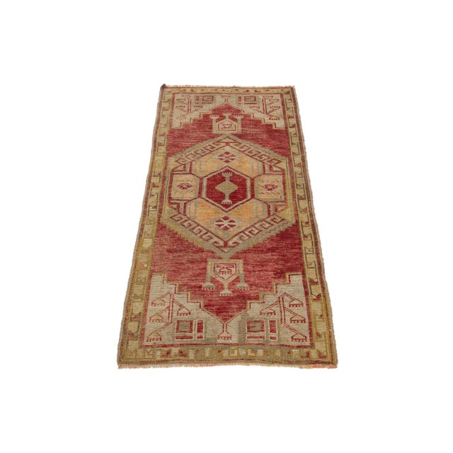 Beautiful vintage Anatolian hand-knotted wool rug featuring a red color field. This piece showcases beige, brown, and...