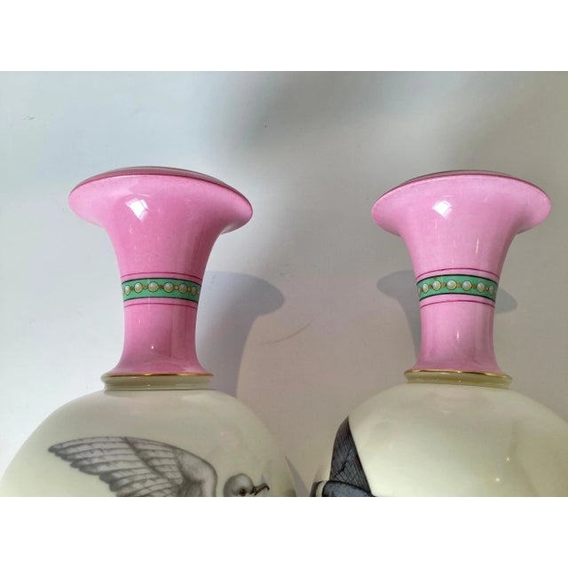 A wonderful pair of French porcelain hand painted vases. The pair with hand painted black sparrows on one side, facing...