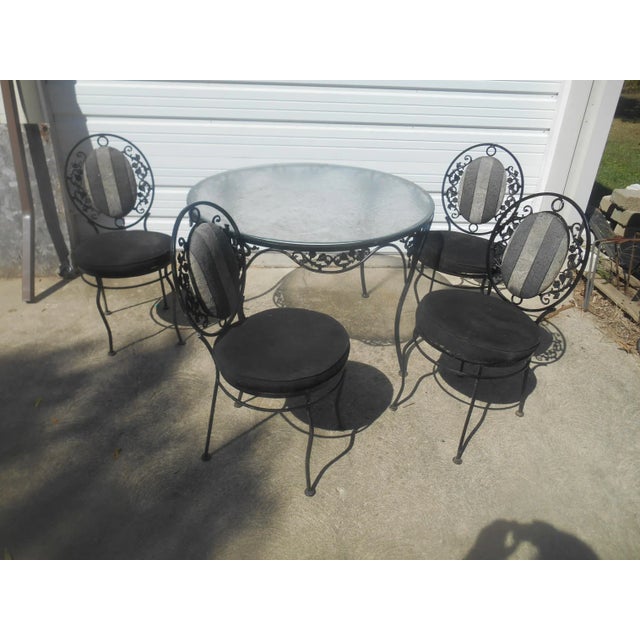 I have a Very Nice Vintage 1960's Russell Woodard Wrought Iron Patio Set. This set has a grape leaf and vine theme on the...