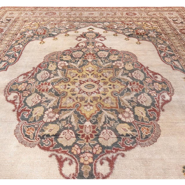 This circa-1920 antique Persian Tabriz carpets features a strikingly elaborate central medallion composed of floral...