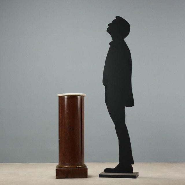 Empire mahogany nightstand. Column with a central opening door and a shelf inside. Plinth base and top in white marble,...