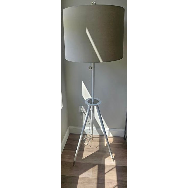 Modern tripod floor lamp from the Ventana collection by designer Jonathan Adler for Robert Abbey. Includes white finished...
