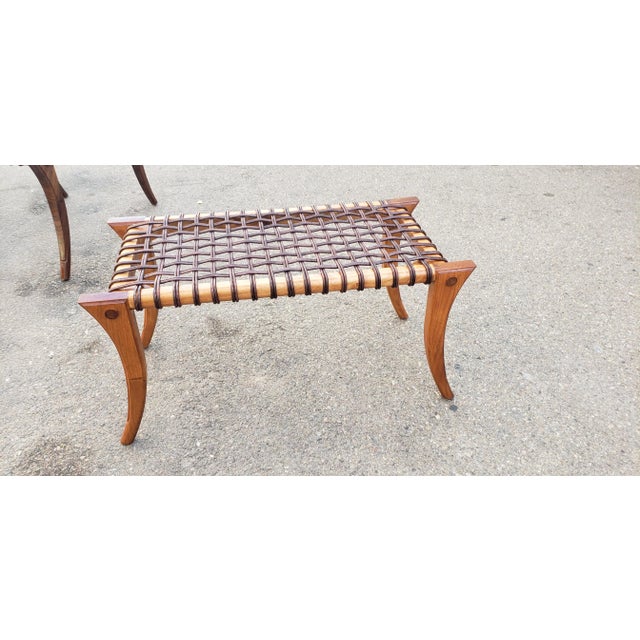 Modern mid century style Klismos ottoman. The ottoman has a custom finish. The color is a golden pecan. The ottoman has...