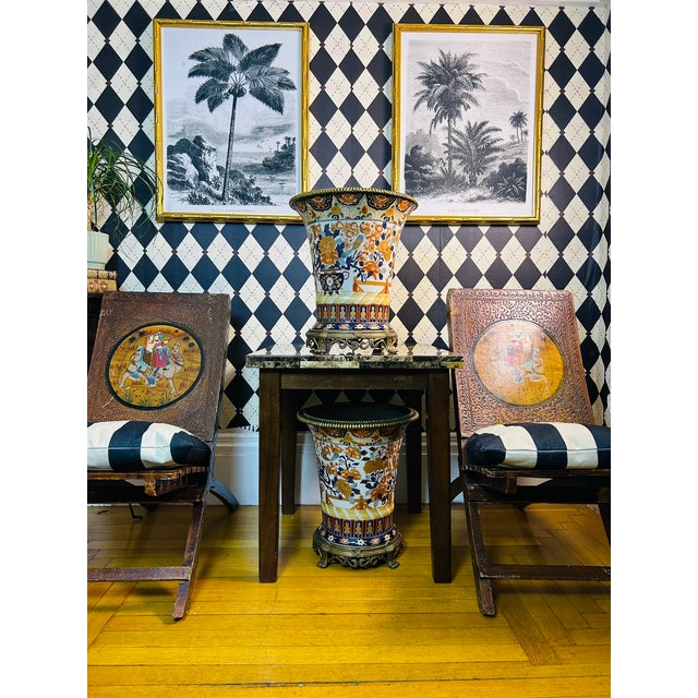 Pair of large vintage Japanese Imari porcelain vases with decorative bronze mounts. The porcelain is densely decorated...