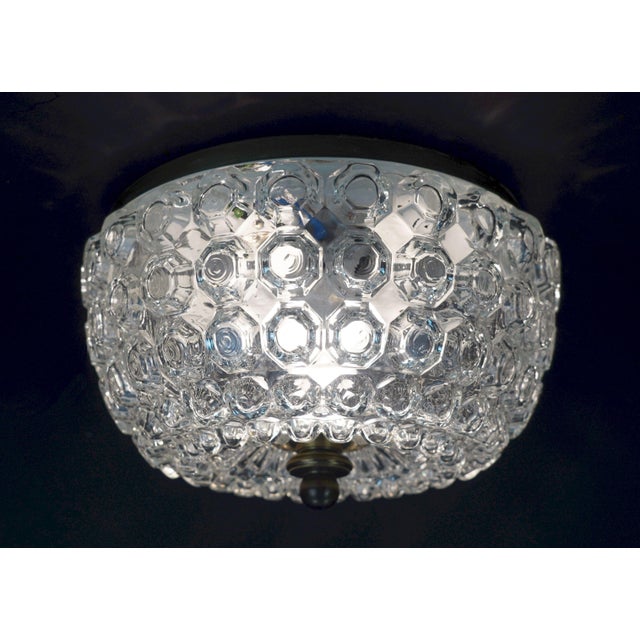 Fantastic vintage ceiling lamp manufactured by Glashuette Limburg in the 1970's. The base is made of metal, it is...