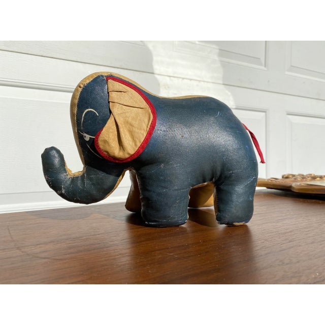a sweet antique primitive handmade folk art elephant stuffed toy. He is completely hand sewn in a wonderful painted canvas...