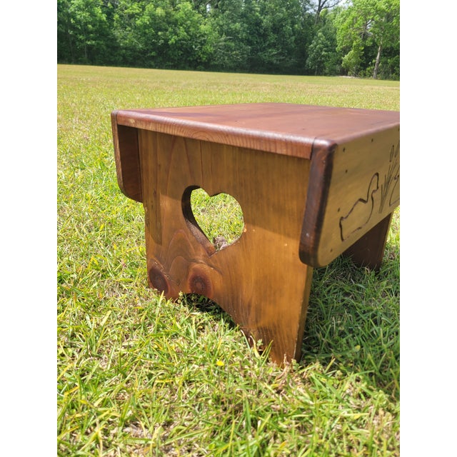 This charming vintage pine step stool perfectly captures a rustic, folk-art aesthetic. Crafted from solid pine with a...