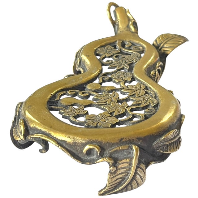A striking vintage brass stand in a classic double-gourd (hulu) form, richly detailed with pierced vine, leaf, and gourd...