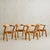 A 1960s French dining set composed of an octagonal dining table and a matching set of four carved oak chairs. Unified by...