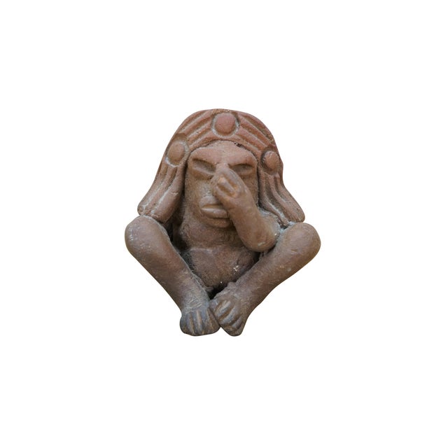 Vintage folk art style red earthenware whistle in the shape of a Mayan / Aztec inspired figure in a headdress, seated with...