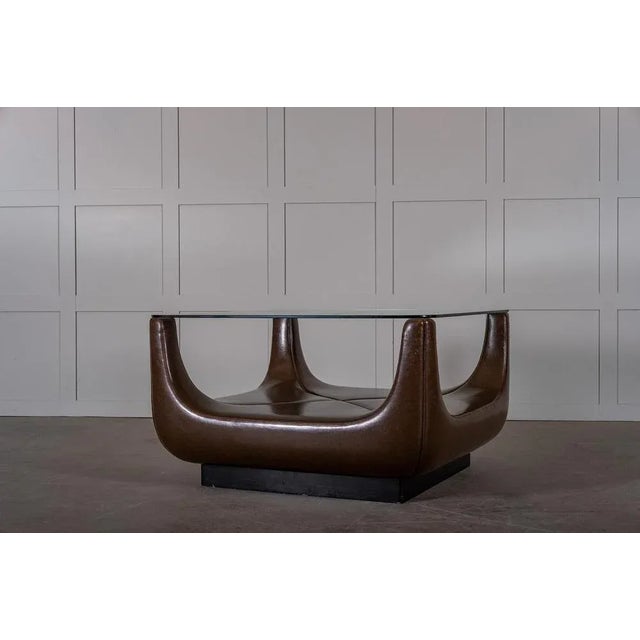 Unknown designer, probably produced in Italy during the 1970s. Glass top and dark brown faux leather.