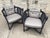 The chairs have a solid, sturdy wooden frame painted in a dark charcoal or black finish. The legs and arms feature elegant...