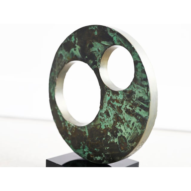 Vintage table top sculpture crafted in solid bronze affixed to a black lucite base. Body of sculpture features a...