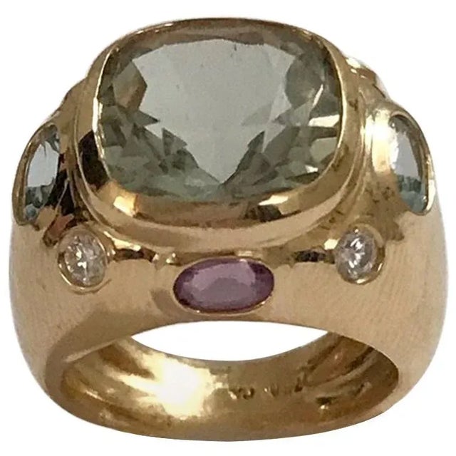 The BONHEUR Ring: 18kt Yellow Gold Domed Ring with faceted 15mm Green Amethyst cushion cut center stone and faceted oval...