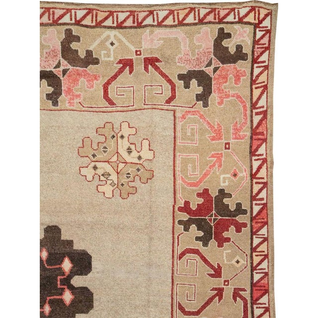 This Mid-20th century Turkish Anatolian square room-size carpet presents a balanced geometric composition centered on a...