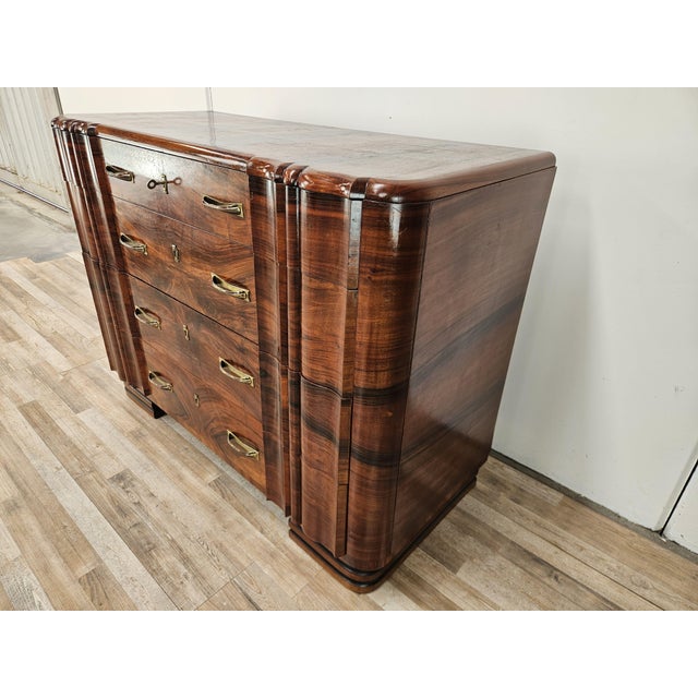 An elegant 1940s Italian Art Deco dresser, crafted from fine walnut veneer and featuring a refined interplay of mirrored...