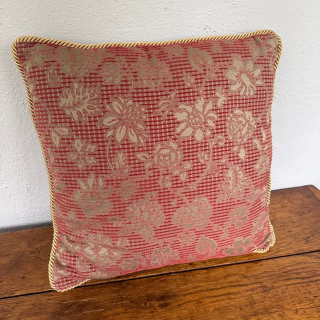 Square woven jacquard pillow with large vining flowers in soft gold over a deep salmon red ground. The woven check gives...