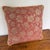 Square woven jacquard pillow with large vining flowers in soft gold over a deep salmon red ground. The woven check gives...