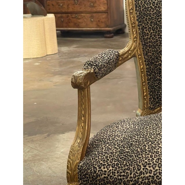 The product is a pair of French Louis XVI giltwood armchairs with leopard upholstery. These elegant and luxurious chairs...