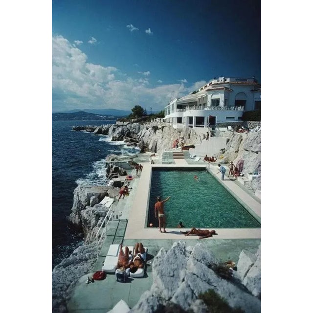 Eden-Roc Pool 1976 by Slim Aarons printed 2024 Slim Aarons Limited Estate Edition Guests round the swimming pool at the...