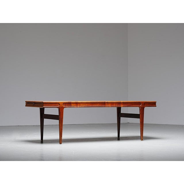 Teak coffee table designed by Johannes Andersen, Denmark, 1960s. Elegant carved frame with Andersen’s signature soft edges...