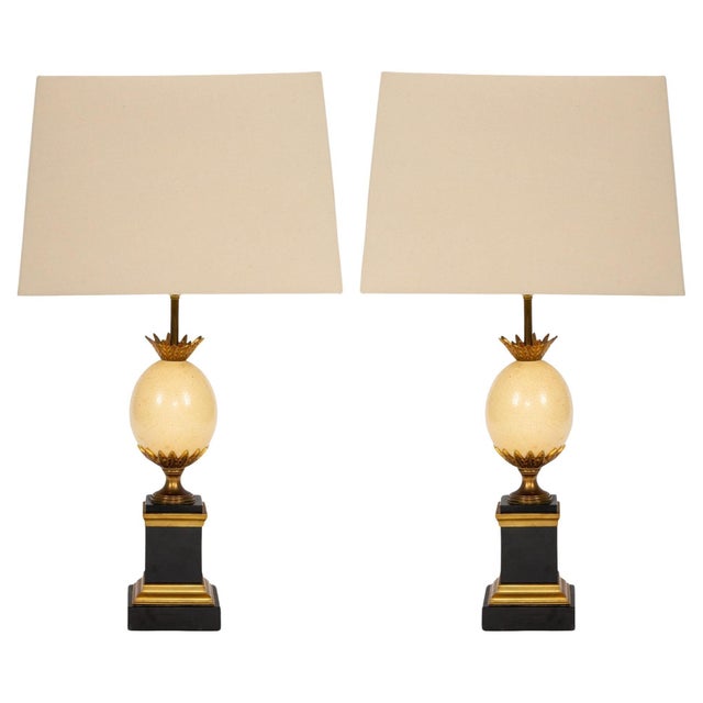 This elegant pair of table lamps is attributed to Maison Charles, Paris, and dates to the mid-20th century, reflecting the...