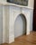 Early 20th century Neoclassical style mantel in white marble. The scrolling keystone carving references Louis XVI styling,...