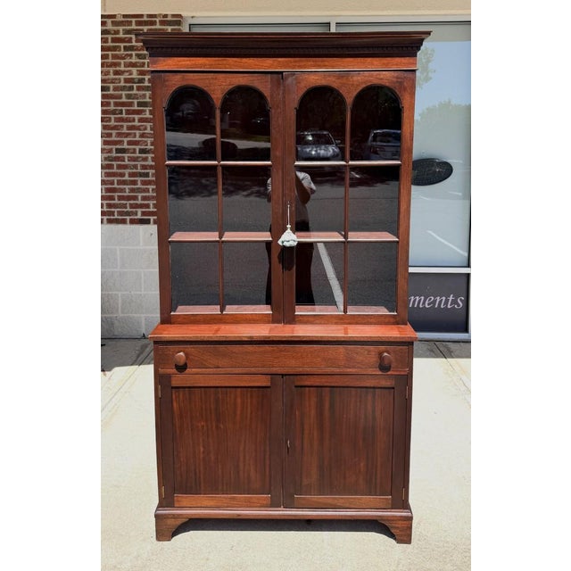 This NC-made step back cupboard is crafted from solid mahogany and features a traditional two-part form with glazed upper...