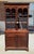 This NC-made step back cupboard is crafted from solid mahogany and features a traditional two-part form with glazed upper...