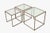 Set of Three Metal and Glass Nesting Tables Modernist / Hollywood Regency Style Europe, circa 1970s. A sleek and elegant...