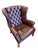 Chesterfield-style Wingback Armchair in red leather with deep-button tufting, they feature rolled arms, brass nailhead...