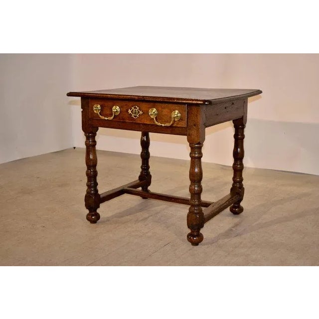 18th Century English side table made from oak with a beveled edge around the top, following down to a simple apron with a...
