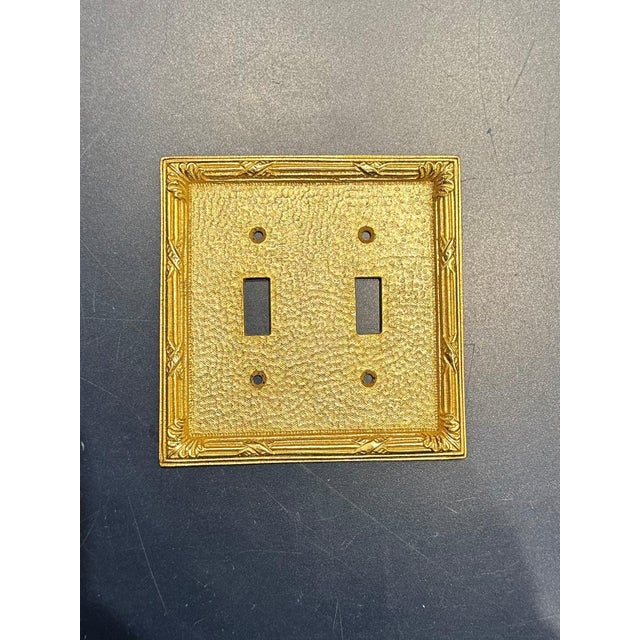 Set of 10 Sherle Wagner Ribbon and Reed Double Switch Plates. Burnished Gold Finish.