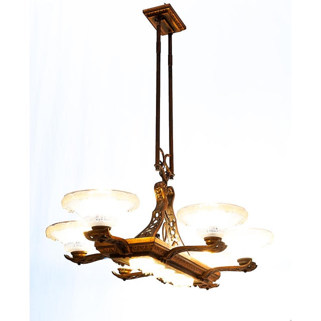 Art Deco ocean liner chandelier. 10 lights. Made by "Ezan France" Brass structure. 6 large globes and 6 small ones in...