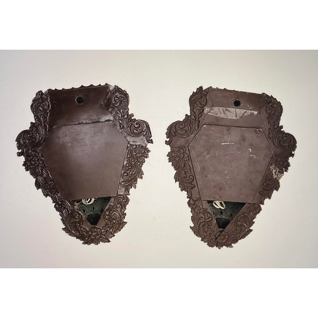 A pair of lantern-like wall lamps made of tin and glass from around 1930. In excellent condition and tested for...