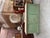 This antique florist’s counter has been fully restored. It features a green patinated base and a raw wood top. At the...
